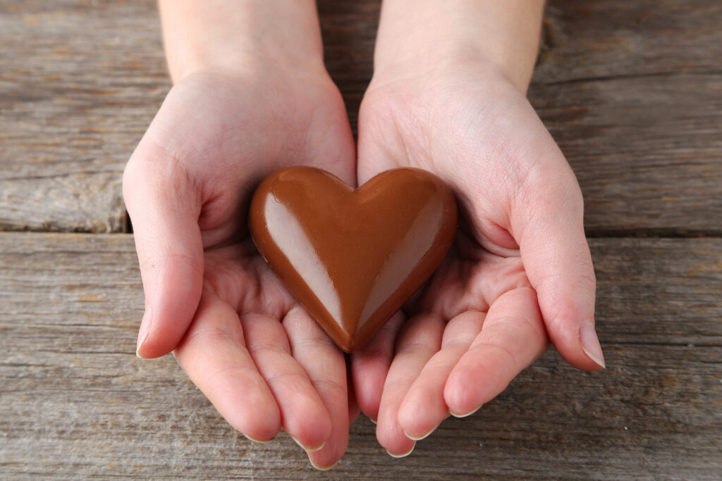Woman's hands with chocolate heart